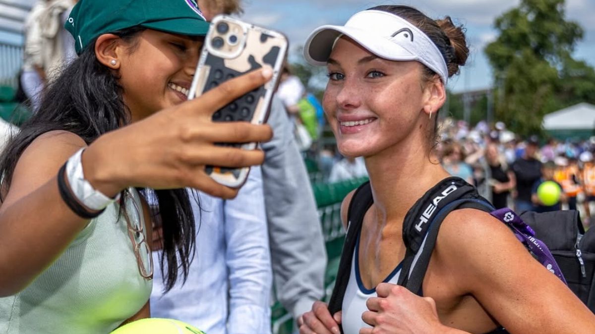 Carson Branstine smiles for a selfie with a fan after her Wimbledon qualifying win
