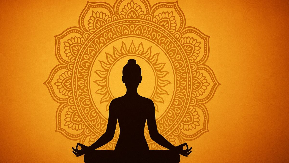 Silhouette of a person meditating in lotus position with a golden mandala background