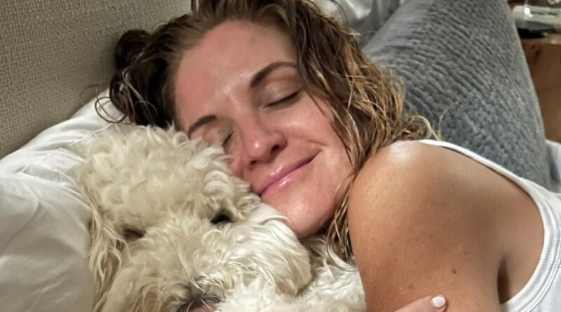 Glennon Doyle cuddling with her dog in a quiet, peaceful moment