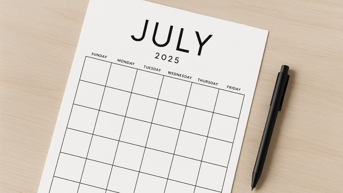 Minimalist July 2025 calendar on wooden desk with black pen