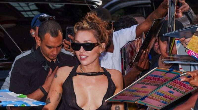 Miley Cyrus in a black sheer dress at NYC album signing