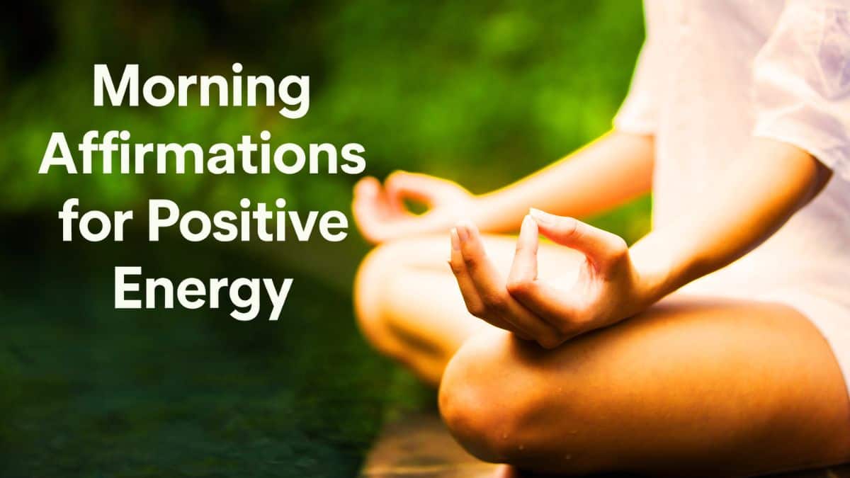 A person in a meditative pose near water with greenery, practicing mindfulness and affirmations