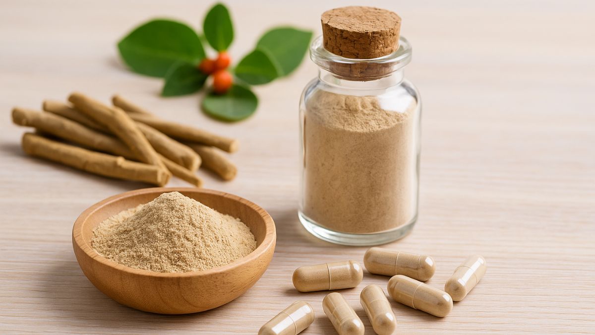 Ashwagandha powder in a bowl with capsules and dried root