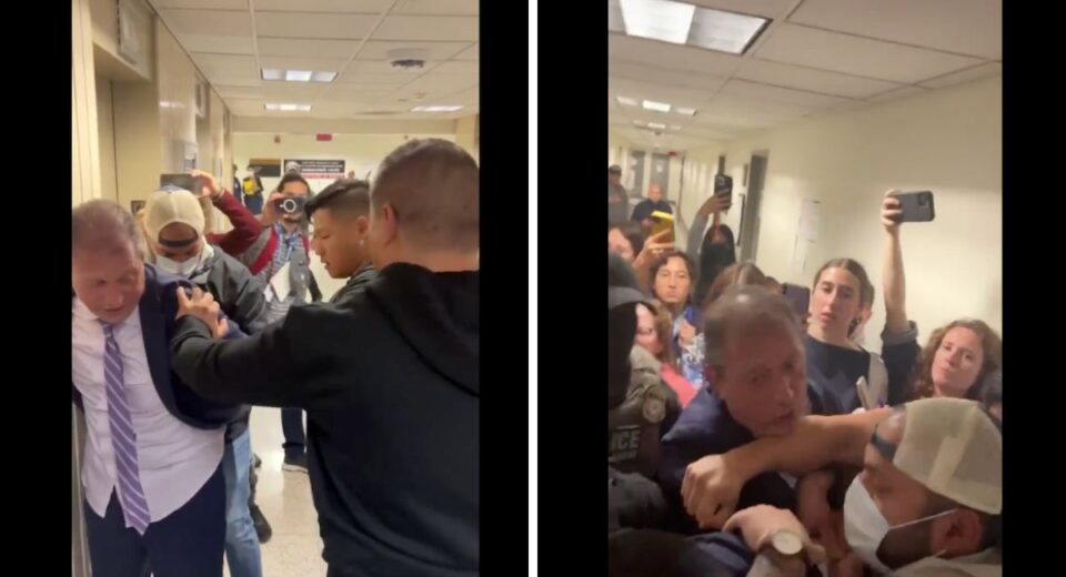 Brad Lander being restrained by ICE agents during a tense hallway encounter at NYC immigration court