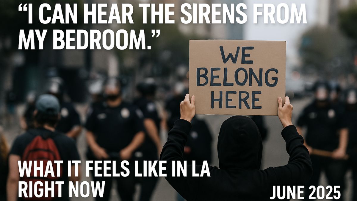 A protester holds a sign that reads “We Belong Here” amid LA riots, June 2025