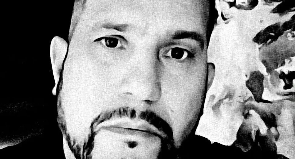 Black-and-white portrait of Dan Rivera, lead paranormal investigator with the Annabelle doll tour