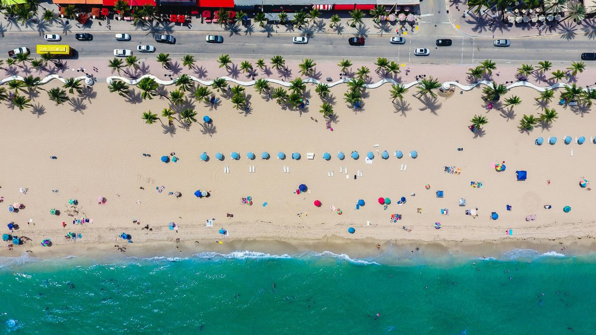 Aerial view of Fort Lauderdale Beach with colorful umbrellas and palm trees