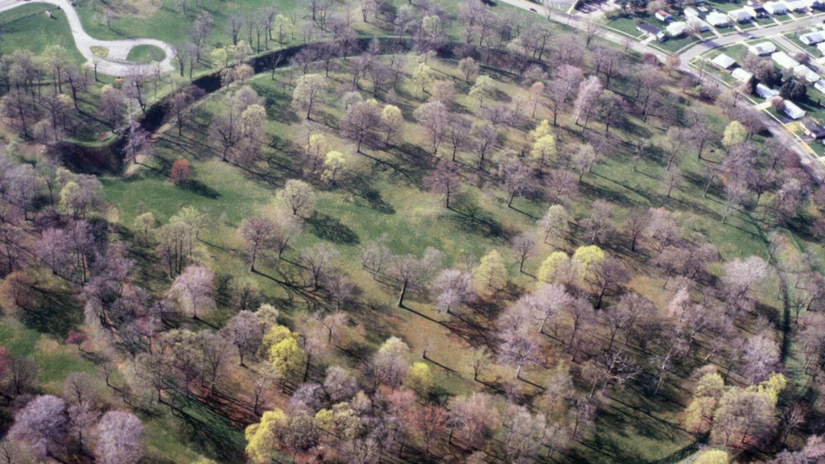 Aerial view of the Great Circle Earthworks in Ohio surrounded by spring trees and suburban homes