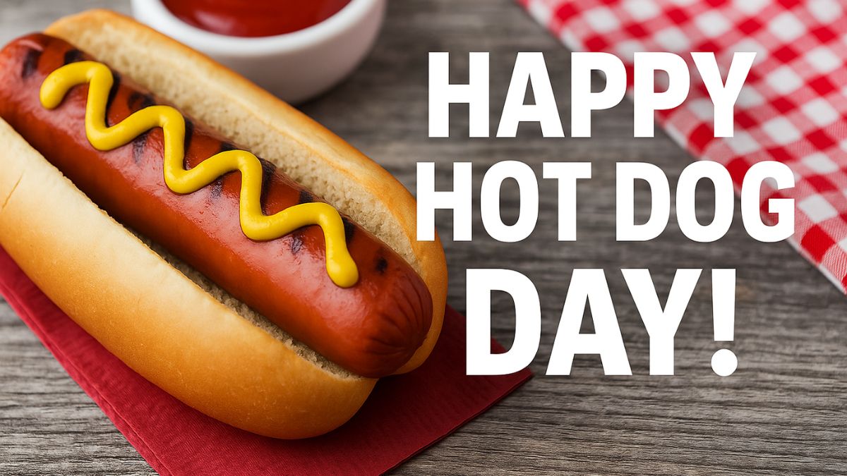 A grilled hot dog with mustard on a bun and bold white text reading “Happy Hot Dog Day!”