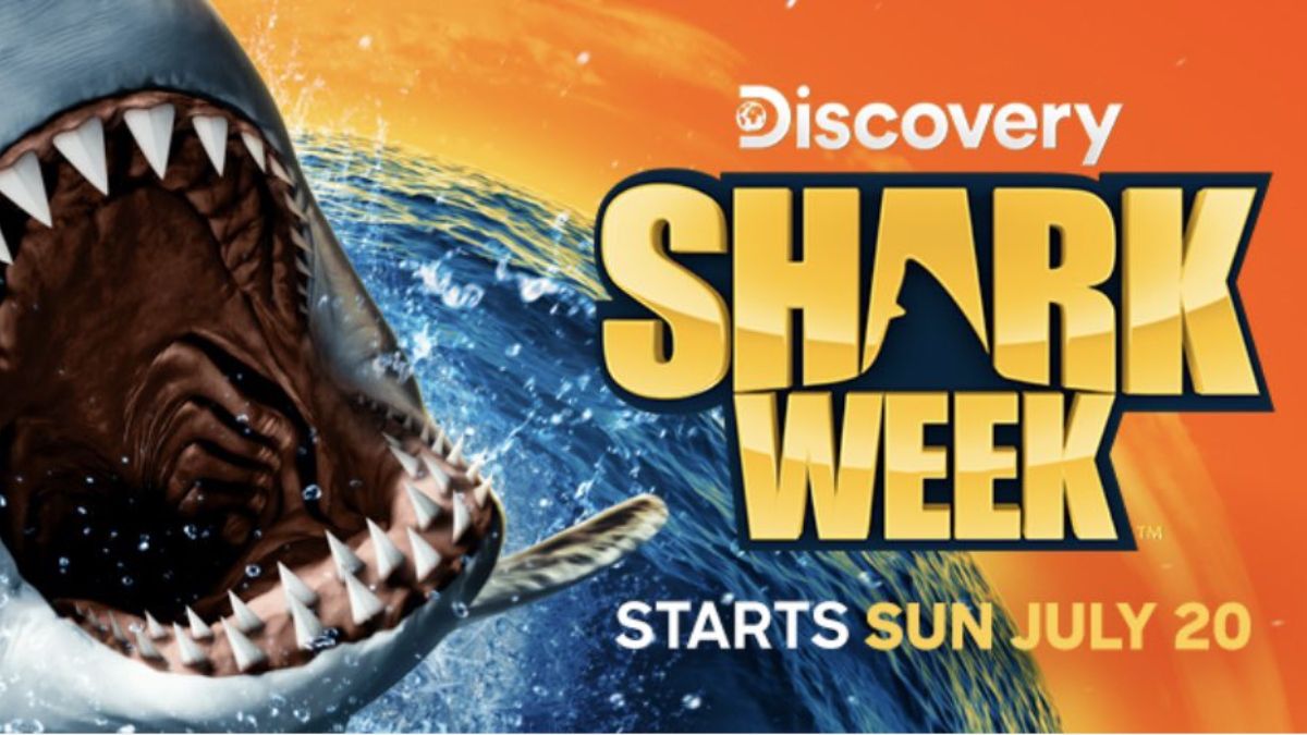 Shark lunging from water with wide open jaws next to Shark Week 2025 title