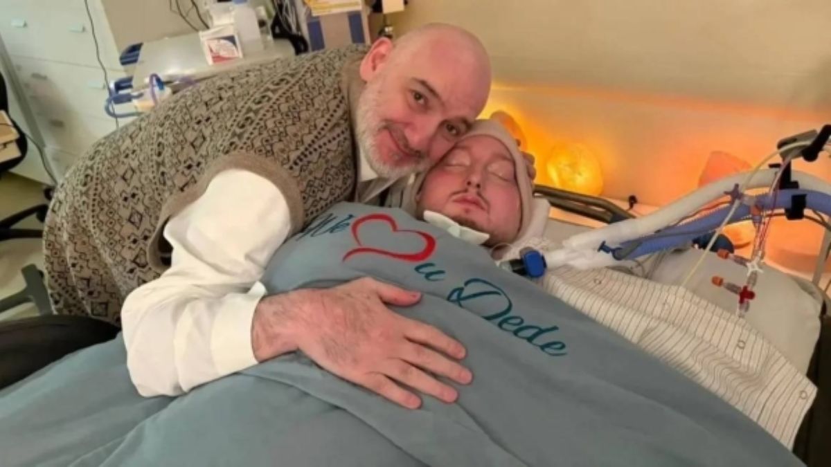 Prince Khaled bin Talal hugs his comatose son, Prince Al-Waleed, while lying beside him in the hospital.