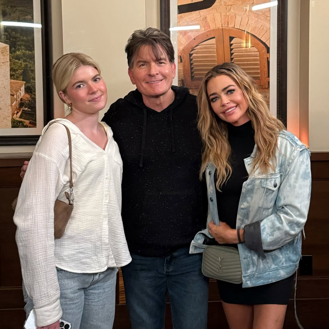 Denise Richards, Charlie Sheen, and daughter Sami Sheen pose together smiling indoors