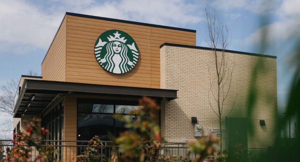Starbucks storefront with logo under a clear sky