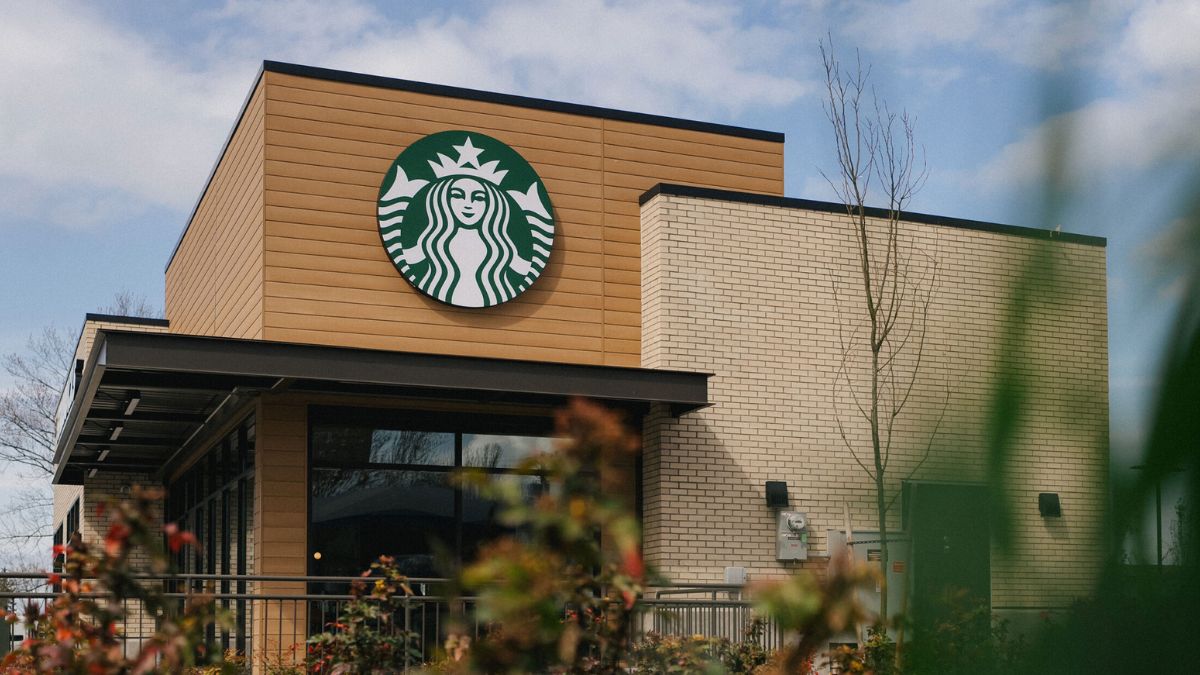 Starbucks storefront with logo under a clear sky