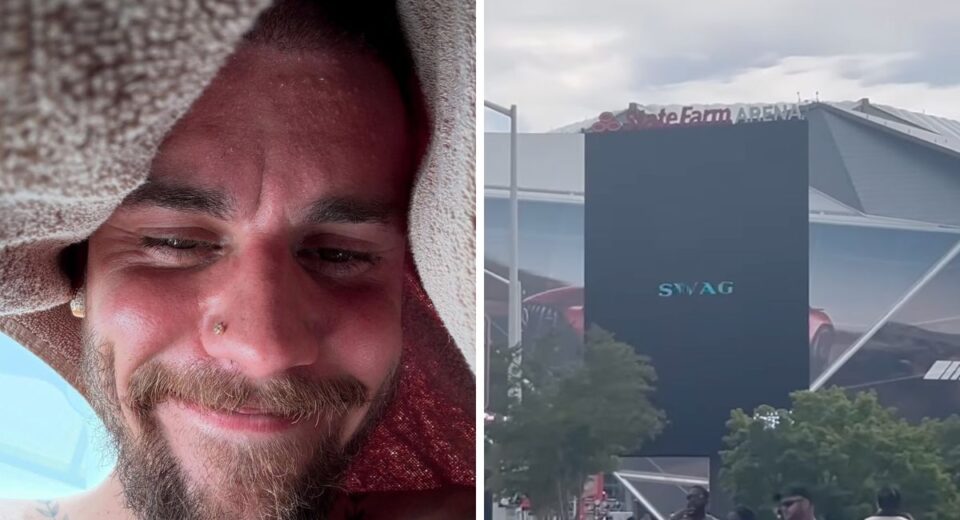 Justin Bieber smiling under a towel alongside a billboard showing the word “SWAG” outside State Farm Arena