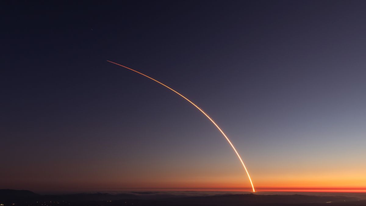 SpaceX Falcon 9 rocket streaks across twilight sky